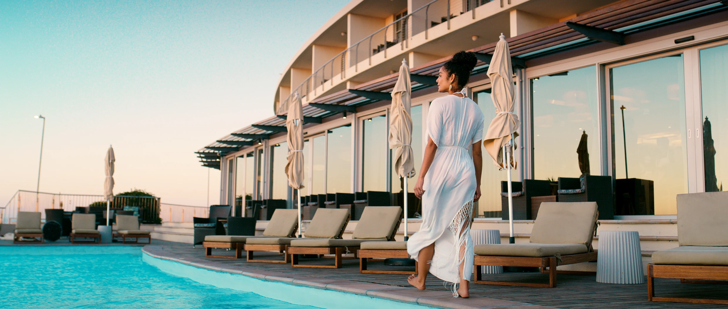 Luxury hotel pool area at sunset