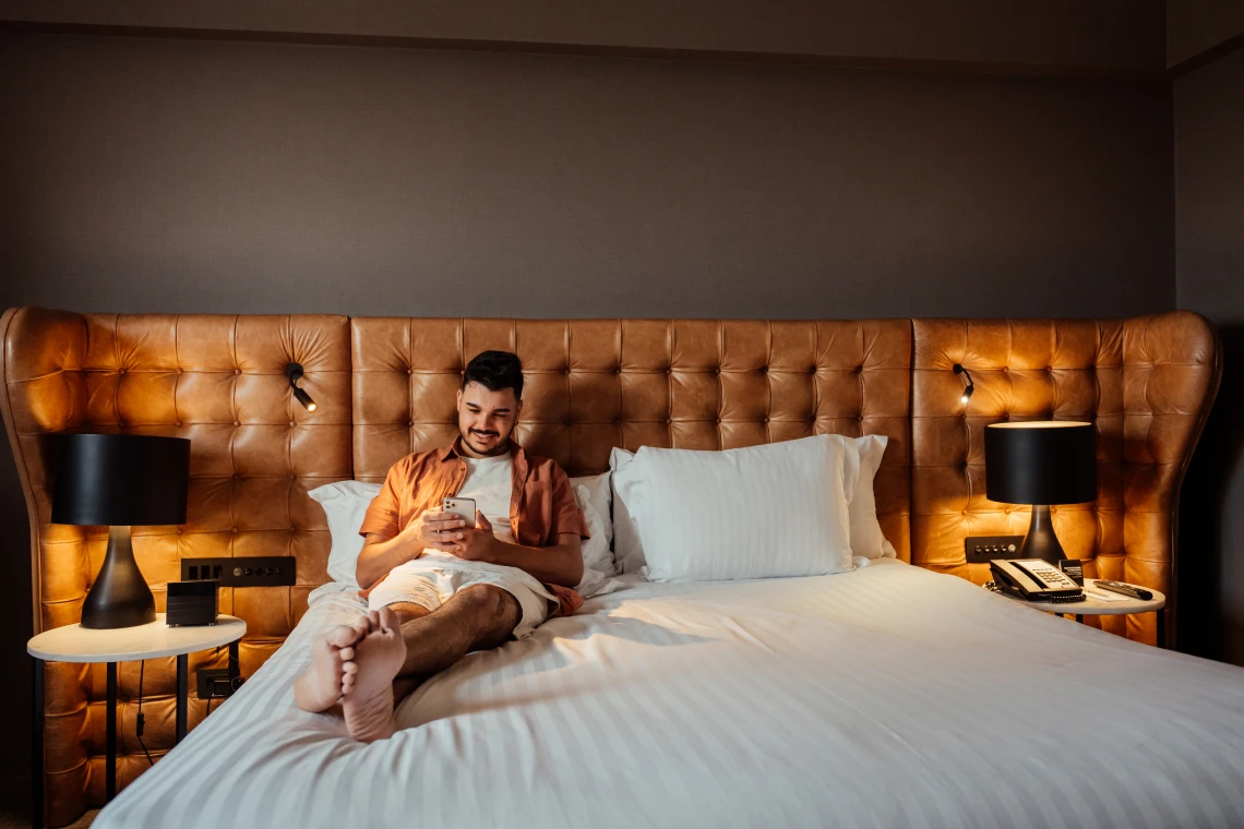 Man enjoying leisure time in hotel room
